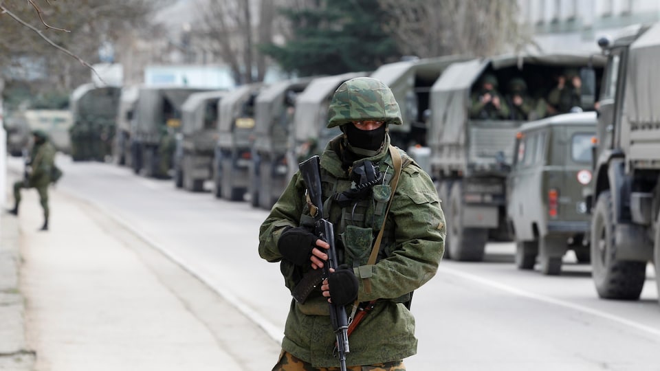 A soldier holds his rifle.