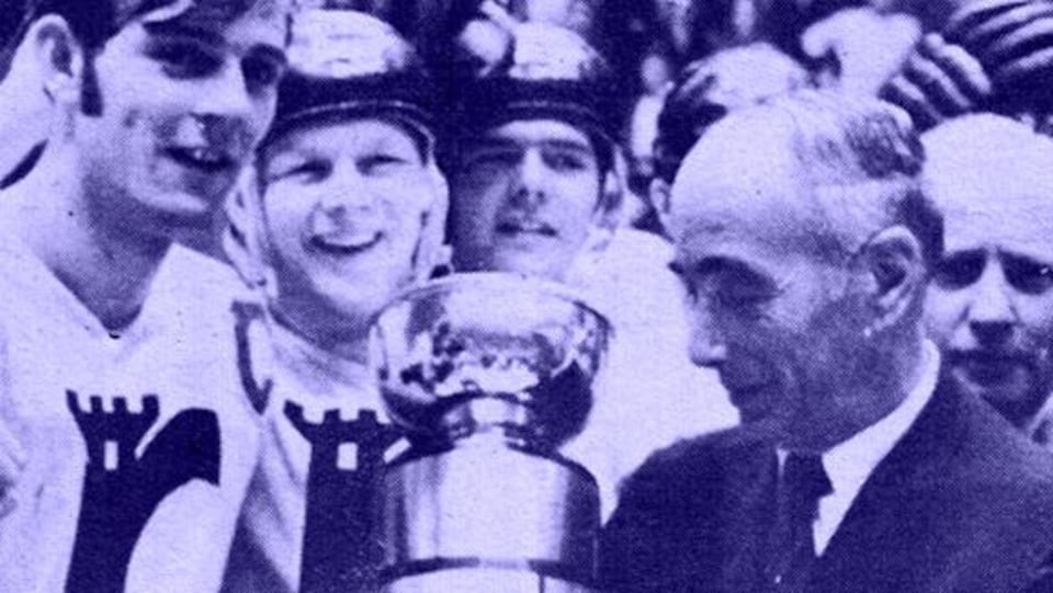 Players celebrate winning a cup. 