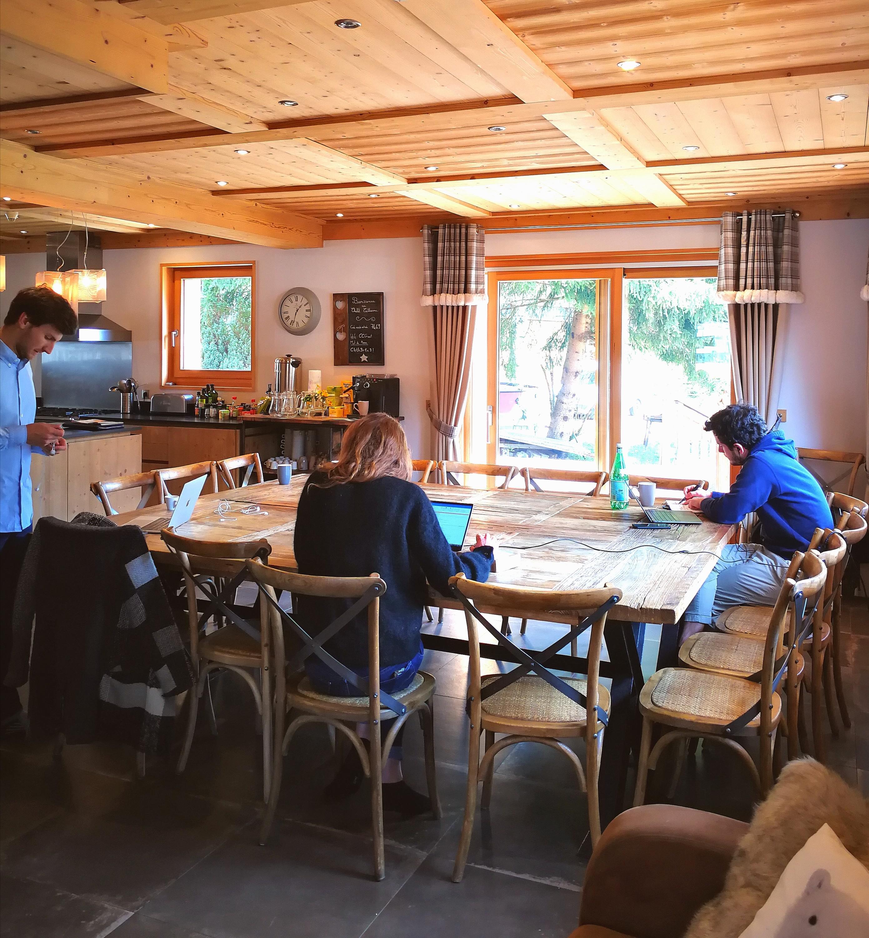 The chalet dining table has become a co-working space.