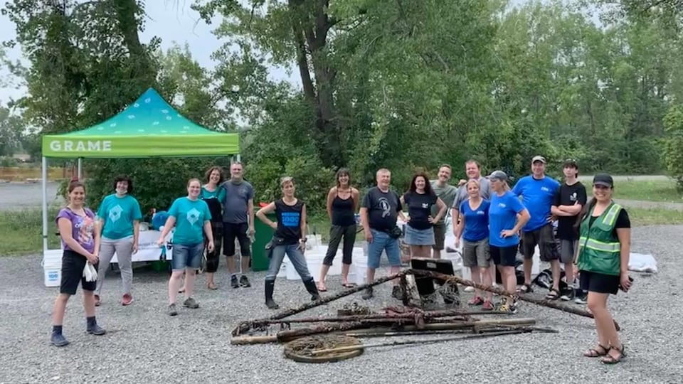 Volunteers standing in front of recovered waste.