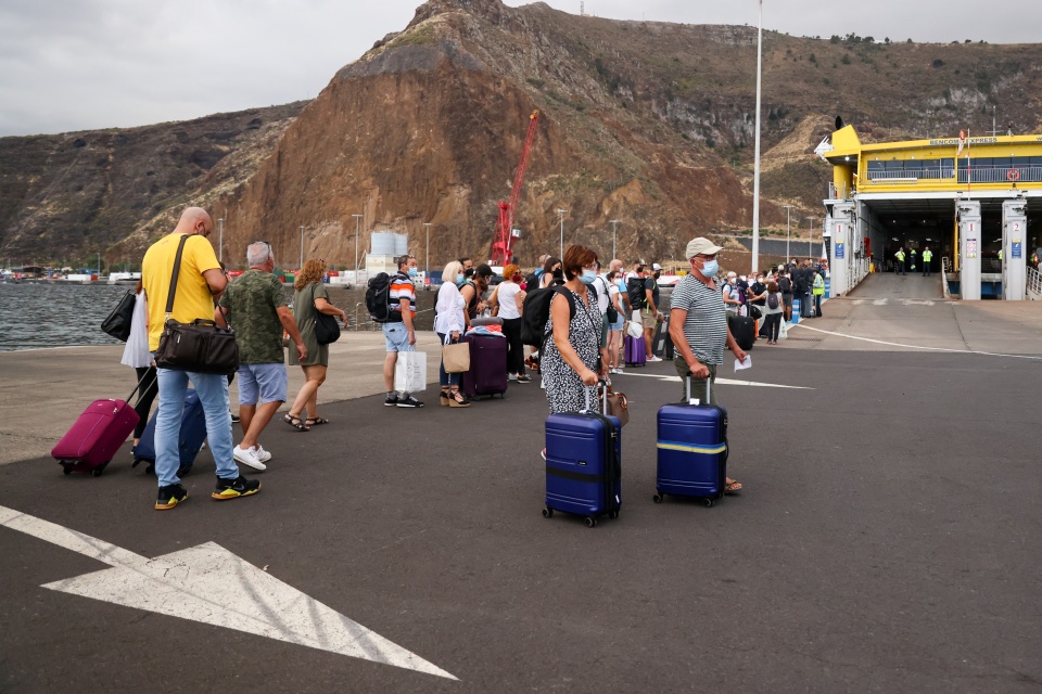 Tourists wait for the ferry to leave the island after La Palma airport closed