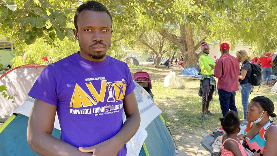 A man in front of a tent. 