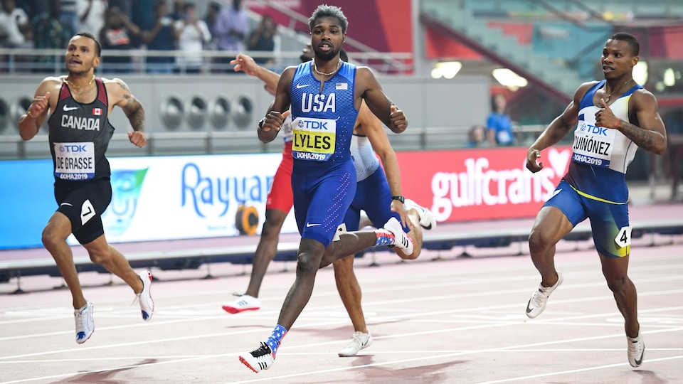 Athletes run on an athletics track.