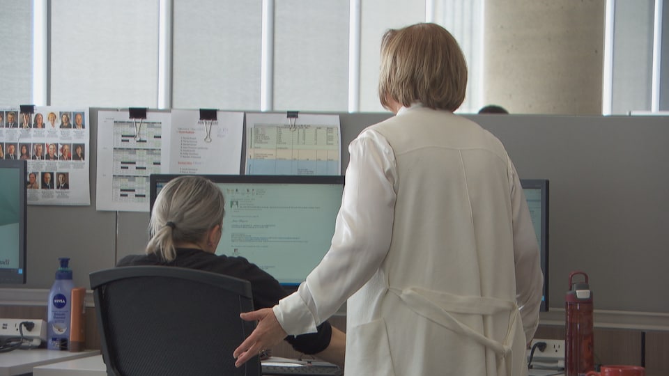 Two employees looking back at an office.