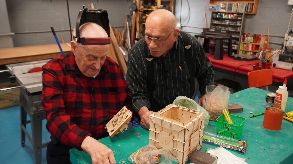 Two people build a head box.