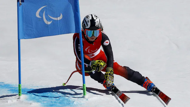 You walk through a gate on the ski slope.