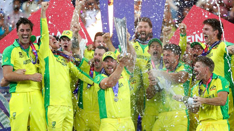 Australian captain Aaron Finch lifts the trophy with his teammates after winning the World Cup Twenty20 final between Australia and New Zealand. 